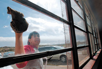 Christian Kauzlarich scrubs down a classroom window at Gallup Catholic High School on Saturday. Student and faculty set aside all day Saturday to tidy up their school for Sunday’s Open House. © 2011 Gallup Independent / Adron Gardner 